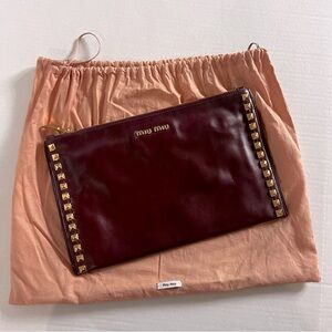 Miu Miu clutch with gold studs